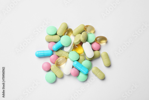 Different vitamin pills on white background, top view