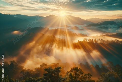 A beautiful sunrise with sun rays and fog over the mountain area