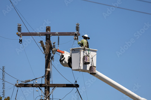 Man works on electrical transmission lines