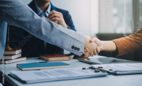 Businessman shaking hands to seal a deal with his partner lawyers or attorneys discussing a contract agreement. photo