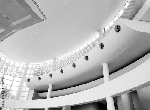 Bangkok, Thailand - April 6 2024: Beautiful white curve inside building interior designed and Architecture detail at ceiling floor in monochrome tone.