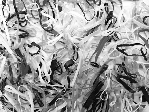 Close up many rubber bands in black and white tone. Pattern group of object in monochrome style.