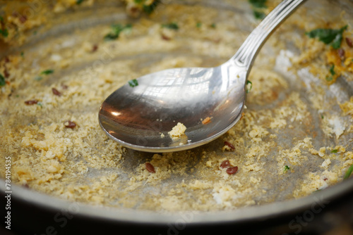 An empty dirty plate with a fork.