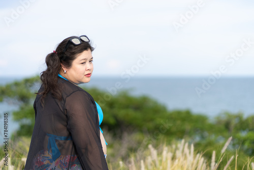 Portrait of Asian Overweight Woman Wearing Sportwear While Vacation at Sea in Summer