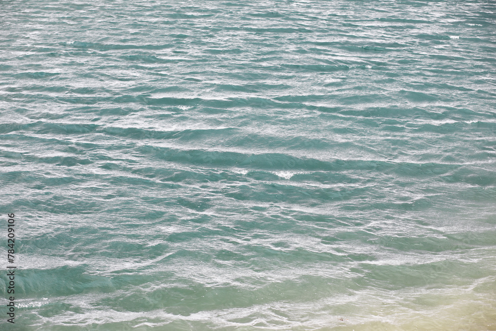 Water surface. The texture of the water. Waves on the lake in windy weather. Water surface. The texture of the water. Waves on the lake in windy weather.