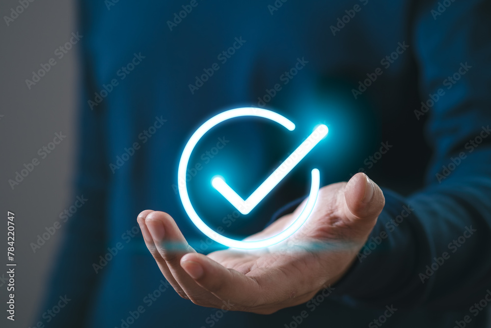 Businessman using holding digital correct sign mark for document online approve paperless and quality assurance concept.
Businessman using holding digital correct sign mark for document online approve paperless and quality assurance concept.