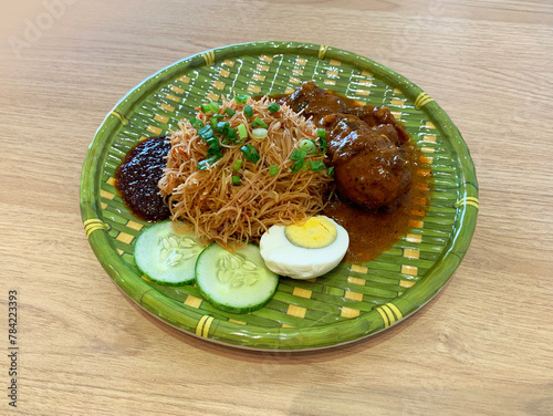 Obraz na płótnie traditional peranakan wok fried nonya mee siam noodle spicy chilli shrimp paste w chicken rendang curry egg sambal cucumber in bamboo plate asian cafe hotel luxury halal food restaurant banquet menu w salonie