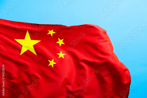 Chinese flag waving on blue background