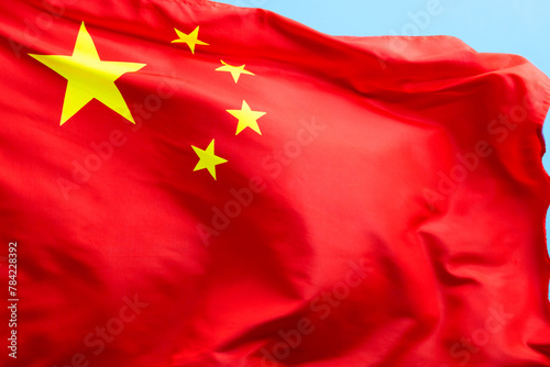 Fotografi Chinese flag waving on blue background