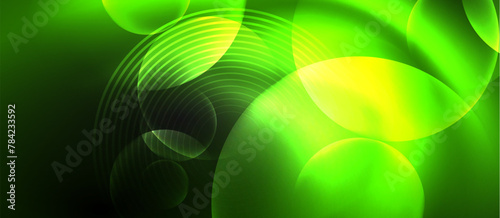 A water drop on a terrestrial plant leaf creates a beautiful pattern with circles and lines. The green and yellow tints and shades enhance the symmetry in this macro photography art