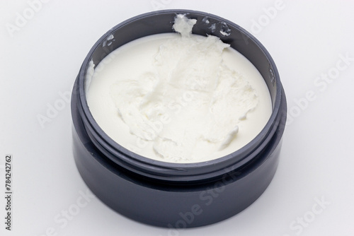 A can of hair paste on a white background. Hair paste is similar to hair gel and is used for styling purposes. (ID: 784242762)