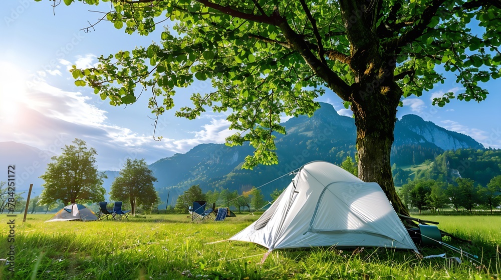 Generative AI : A white tent under a tree on a green grass with mountain on the background