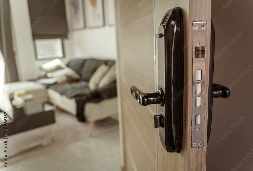 Modern smart door lock on the wooden door in a cozy apartment Modern smart door lock on the wooden door in a cozy apartment