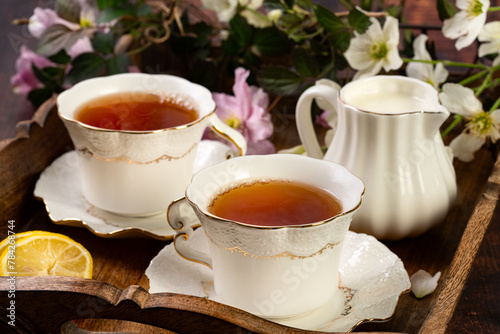 Pretty porcelain teacup with black tea