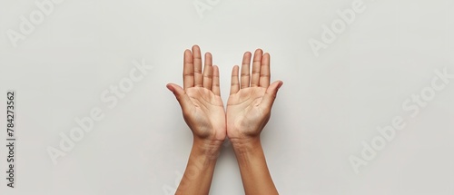Top view of cupped open hands on clean studio white backdrop with a big space for text or product advertisement, Generative AI.