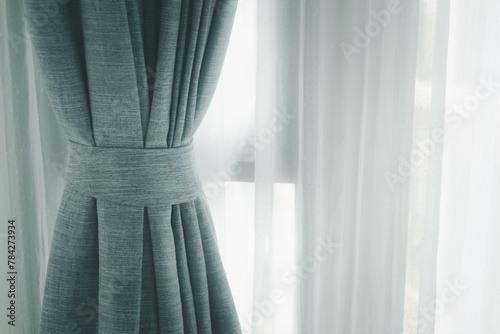 Curtain decotaion on window in home. The soft light filtering through curtains casts delicate that create a soothing and calming ambiance photo