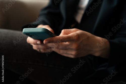 Business woman using mobile phone, browsing social media, texting messages