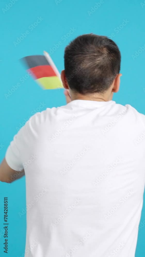 Rear view of a man waving a german pennant Rear view of a man waving a german pennant