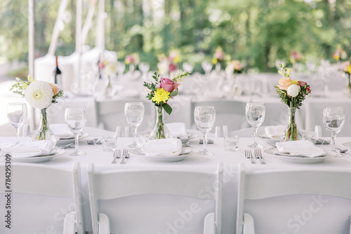 White wedding reception table with floral decor