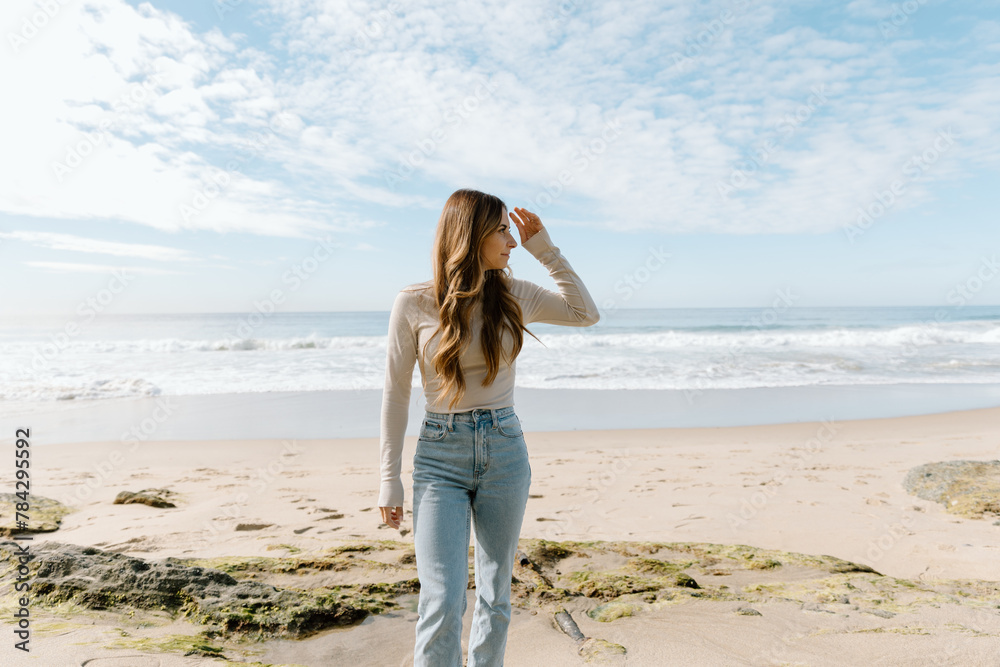 Young woman walking on California beach Young woman walking on California beach