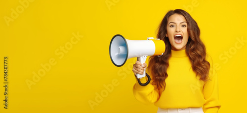 Young woman holding  megaphone smiling cheerfully  for inform and annouce a promotion and advertising photo
