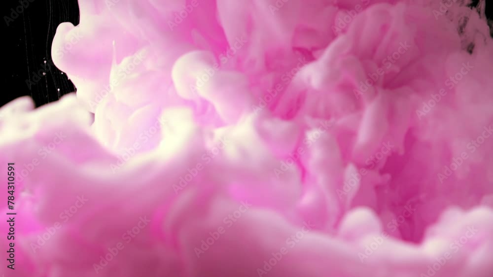 Ink in water. pink ink drops in water and mixes, swirling softly underwater on black background. acrylic cloud paint in aquarium. abstract background, texture, 4K