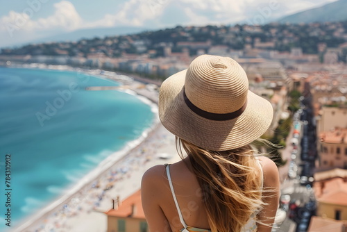 Woman standing on a hill looking at the ocean from above