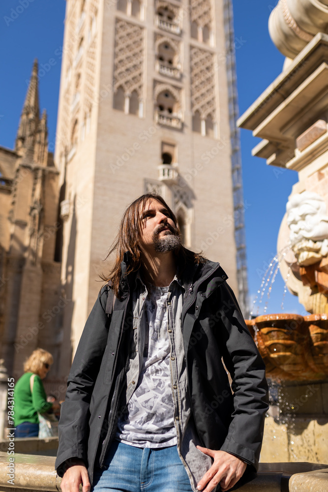 Tourist on vacation next to the Cathedral of seville, Andalucia, Spain