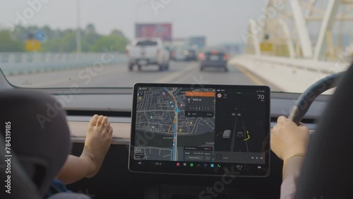 Adorable little boy leisure in car travel with navigator summer vacation trip. transport technology photo