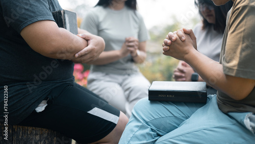 Christian woman held hands with the group, expressing their faith through prayer and devotion to God, uniting in their shared religion. Friends, Group christian pray concept.