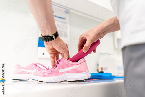 Orthopedic insole. The orthopedist works with the patient. Orthopedic clinic. Choice of insoles in an orthopedic clinic. The orthopedist offers the insole to the patient Foot care photo