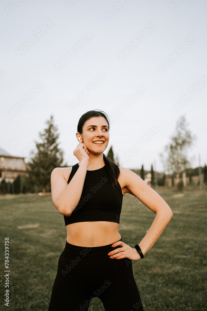 A young woman in sportswear does fitness exercises at sunset in nature. Healthy lifestyle concept. Fitness and sport