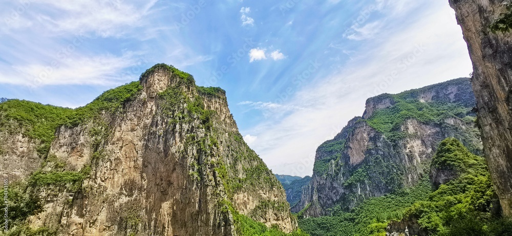 Beautiful scenery of rocky greenery hills and blue cloudy sky Beautiful scenery of rocky greenery hills and blue cloudy sky