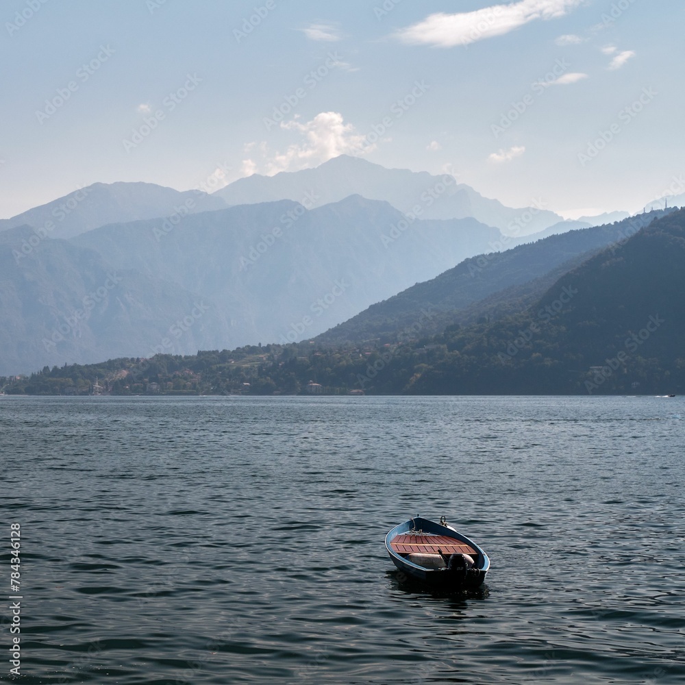 Small wooden boat on Como Lake during the daytime