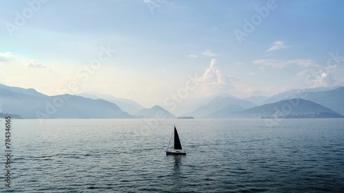 Beautfiful view of a boat sailing on the lake Maggiore, Italy
