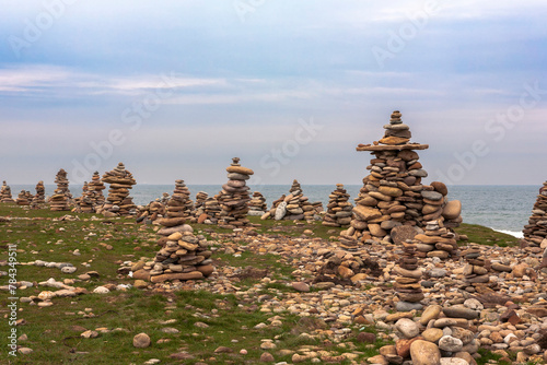 Holy Island of Lindisfarne, Northumberland, UK; a forest of tourist-laid stone cairns on Castle Point, in conflict with the Leave No Trace ethic