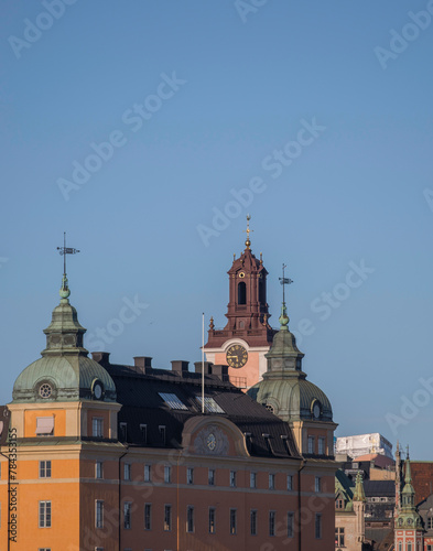 Tower and spires of an old brick apartment house on the hill Mariaberget a sunny spring evening in Stockholm