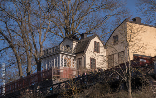 Old 1700s houses on the hill Mariaberget and the vista viewpoint border walk Monteliusvägen in the district Södermalm a sunny spring evening in Stockholm