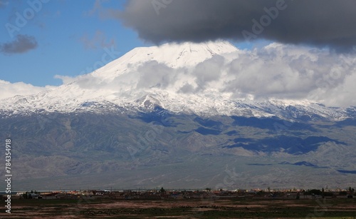 snow covered mountains against the sky and the ground below them © Wirestock