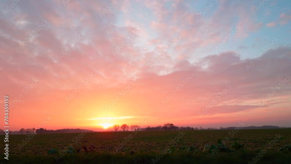 Time-lapse view of a sunset with colorful clouds Time-lapse view of a sunset with colorful clouds