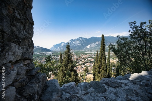 Landscape of buildings and hills in Limone sul Garda under a blue cloudy sky in Italy photo