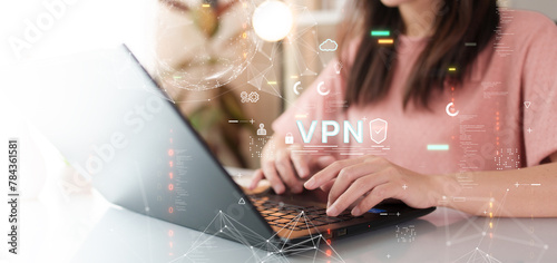 VPN (Virtual Private Network). Cyber security technology concept. A woman is typing on a laptop.