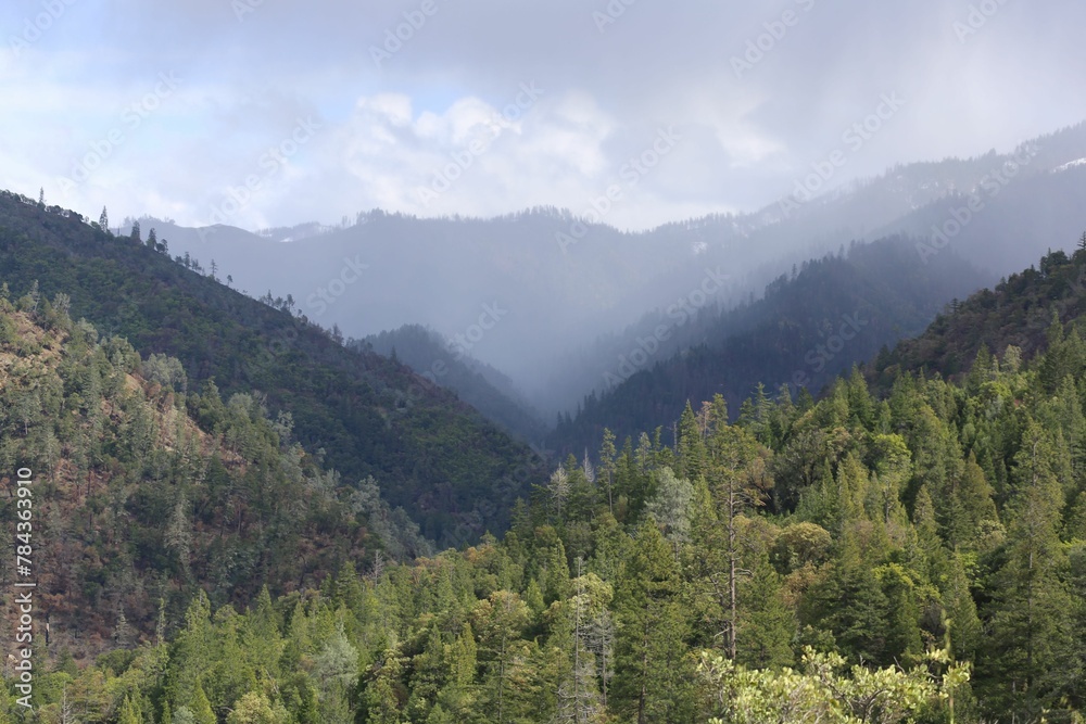 Scenic view of green mountain forests under the cloudy sky
