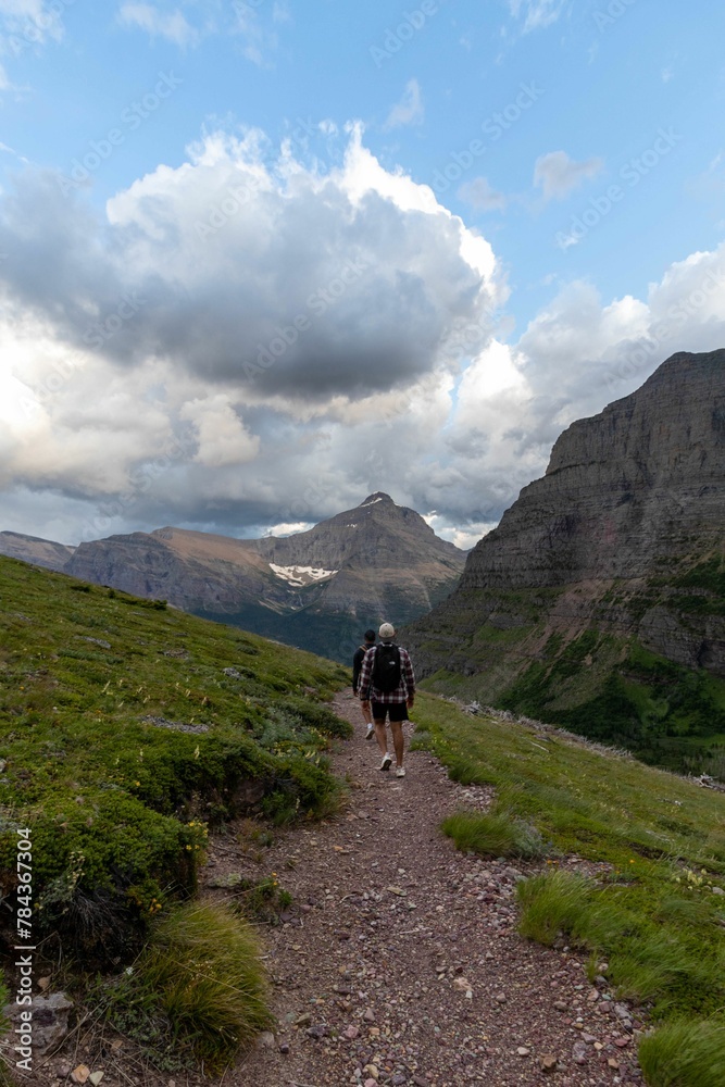 Beautiful view of man hiking the mountains in Glacier national park in Montana
