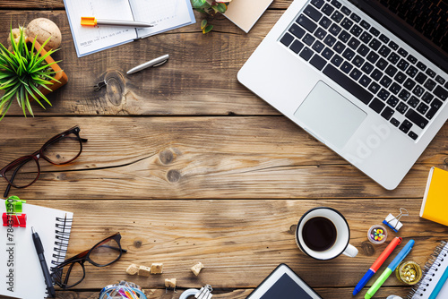 Workspace with laptop, notebook, coffee, and office supplies