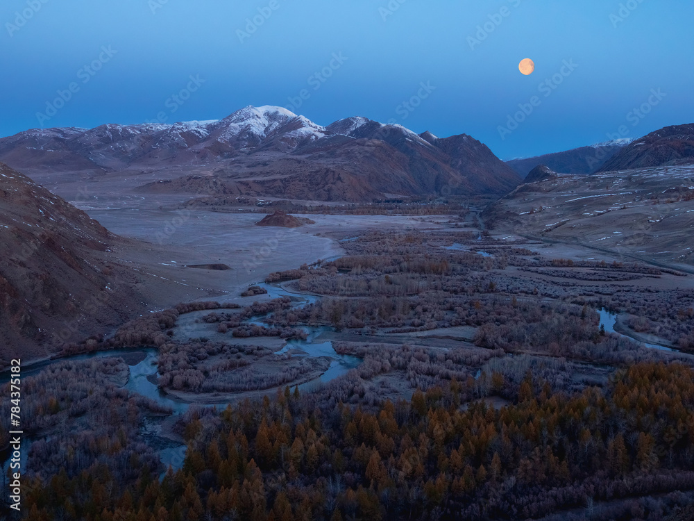 Amazing mystical moonlit night in a mountain valley.