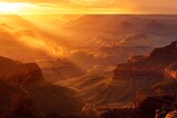 The sun dips below the horizon, casting a warm golden light over the majestic Grand Canyon