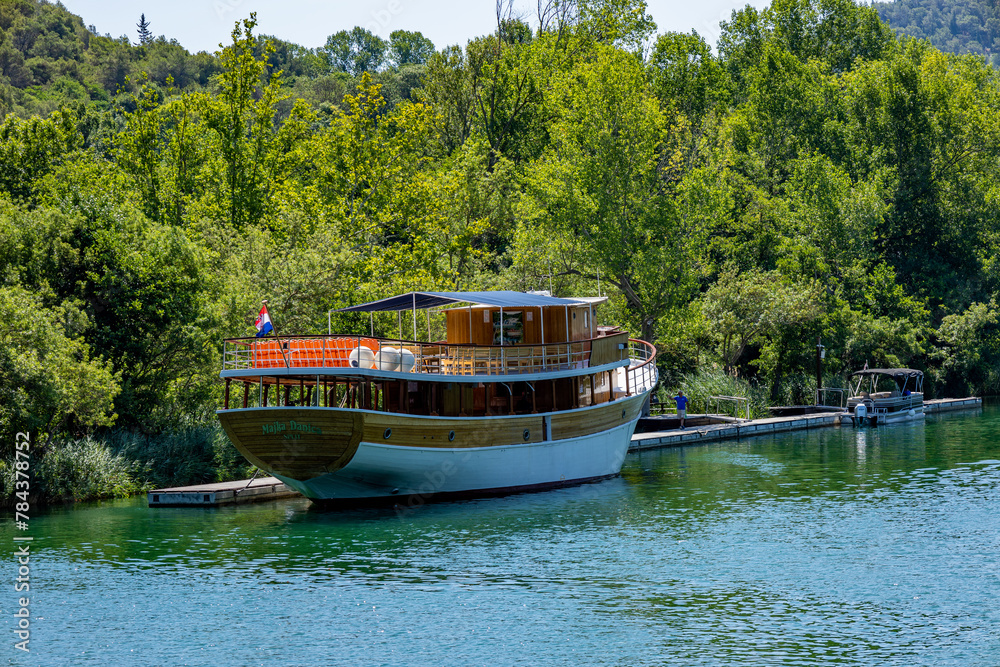 Beautiful landscape in the Krka National Park in Croatia. Natural Waterfalls. Natural wonders. A tourism boat sailing on the water near Krka National Park, Croatia Beautiful landscape in the Krka National Park in Croatia. Natural Waterfalls. Natural wonders. A tourism boat sailing on the water near Krka National Park, Croatia