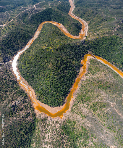 Aerial drone view of Cerro Salomon, salomon hill, with the meander of the red river, Rio Tinto and the Salomon Bridge, old railway bridge used for the transportation on copper mineral to Huelva city photo