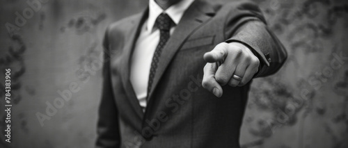 A man in a suit pointing directly at the camera. Suitable for business concepts